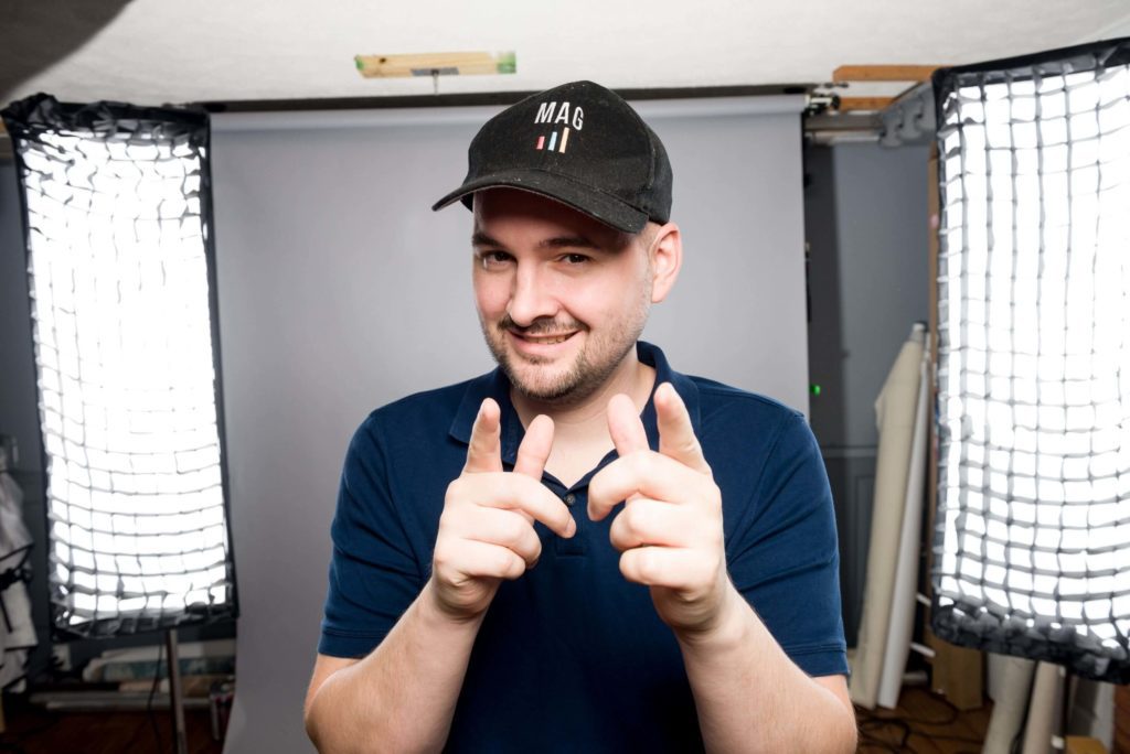 A man in a hat is making a hand gesture in front of a camera, demonstrating his skill in account management.