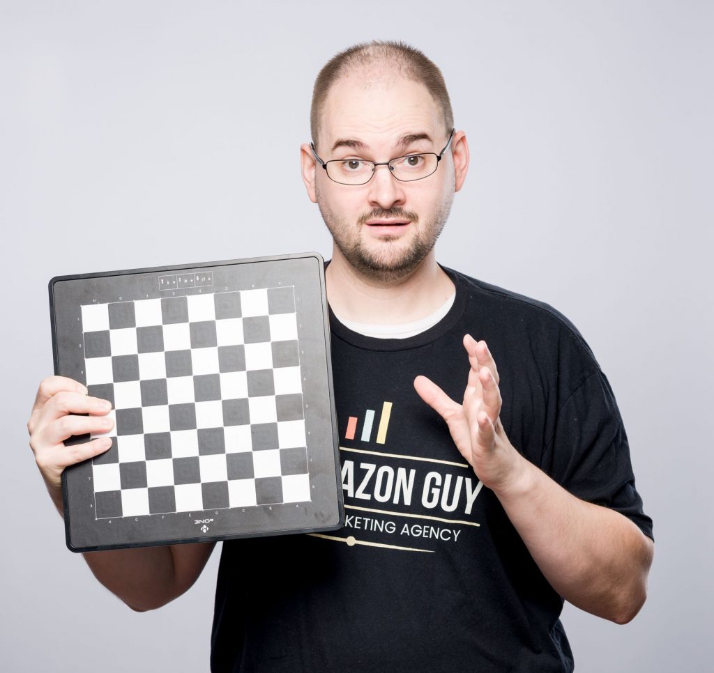 A man holding up a strategic chess board.