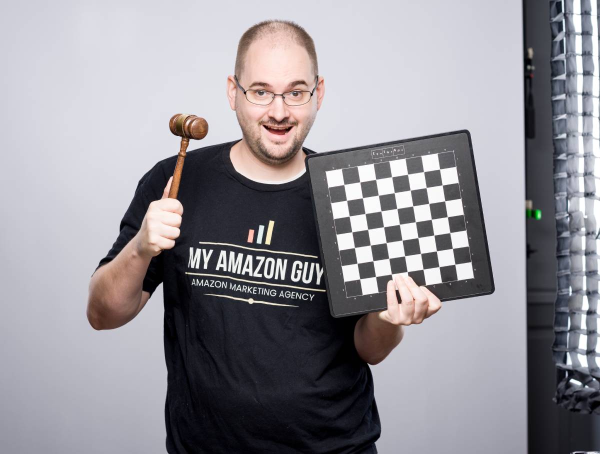 A man holding a chess board and a gavel, demonstrating his expertise in marketing management and account management.
