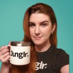 A woman holding a mug that says jungler while utilizing marketplace management offered by My Amazon Guy.